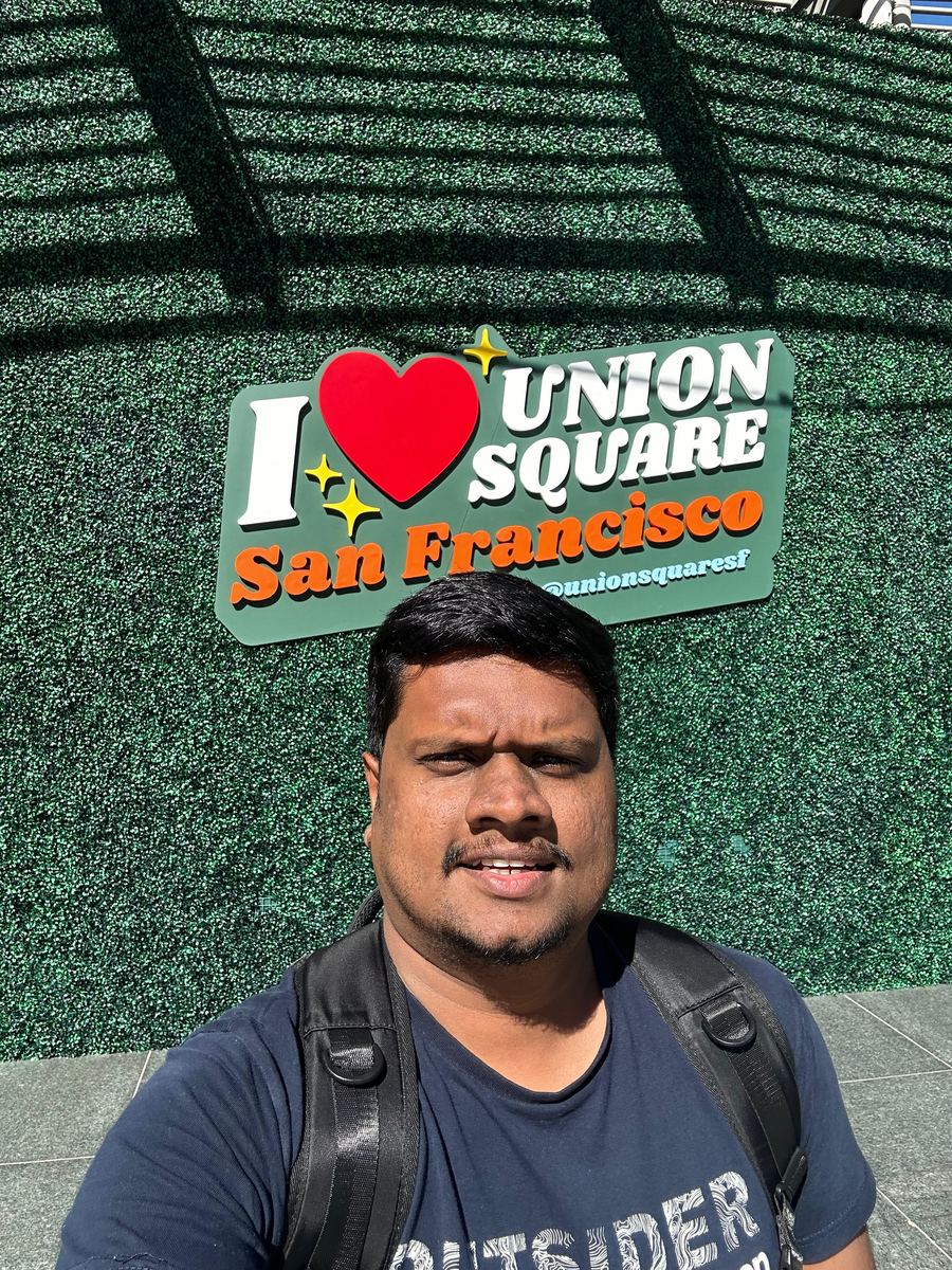 Dulan Dias in front of the I love Union Square sign in downtown San Francisco