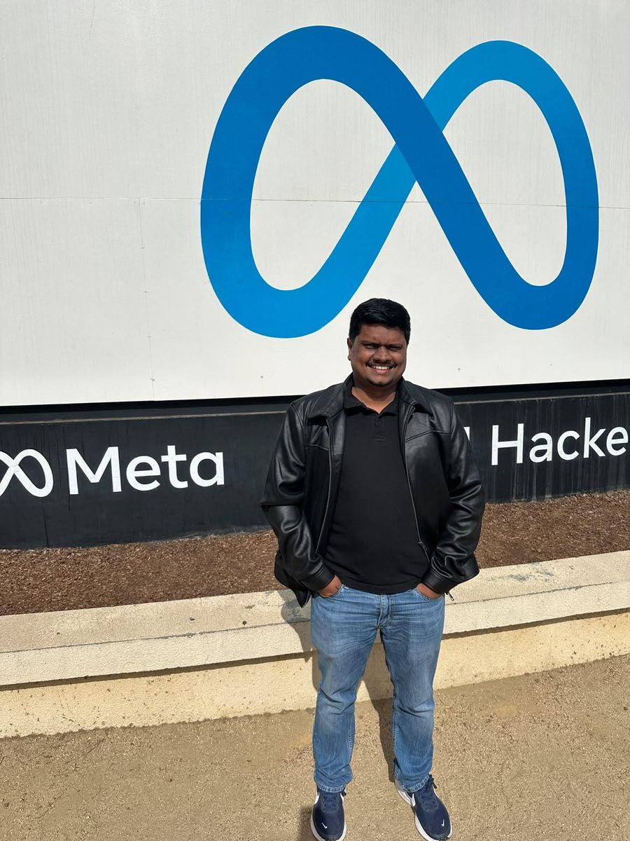 Dulan Dias standing in front of the Meta sign at 1 Hacker Way, Menlo Park